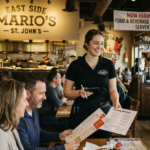 A professional server - food and beverage services presenting the menu to customers at East Side Mario’s restaurant.