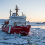 Canada Coast Guard icebreaker sailing through Arctic sea ice